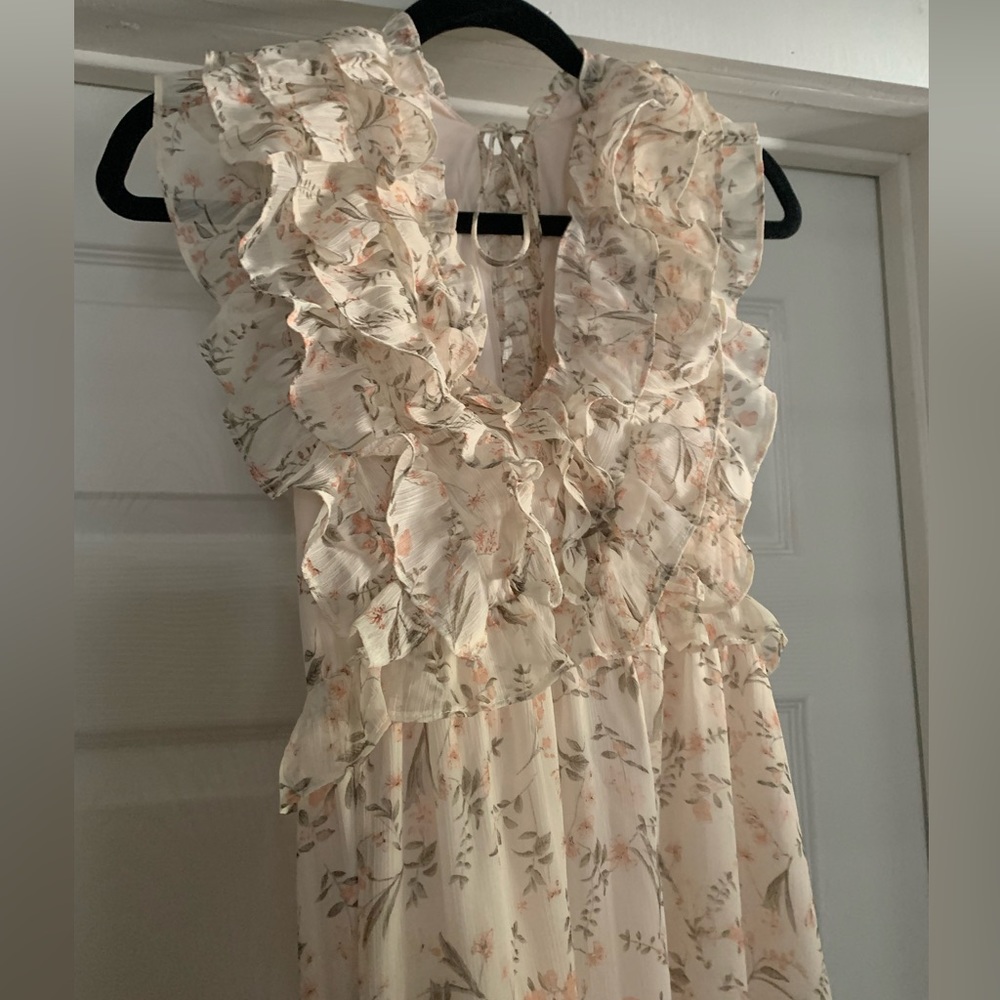 Sweet floral dress with ruffles at the neckline and tiers at the base